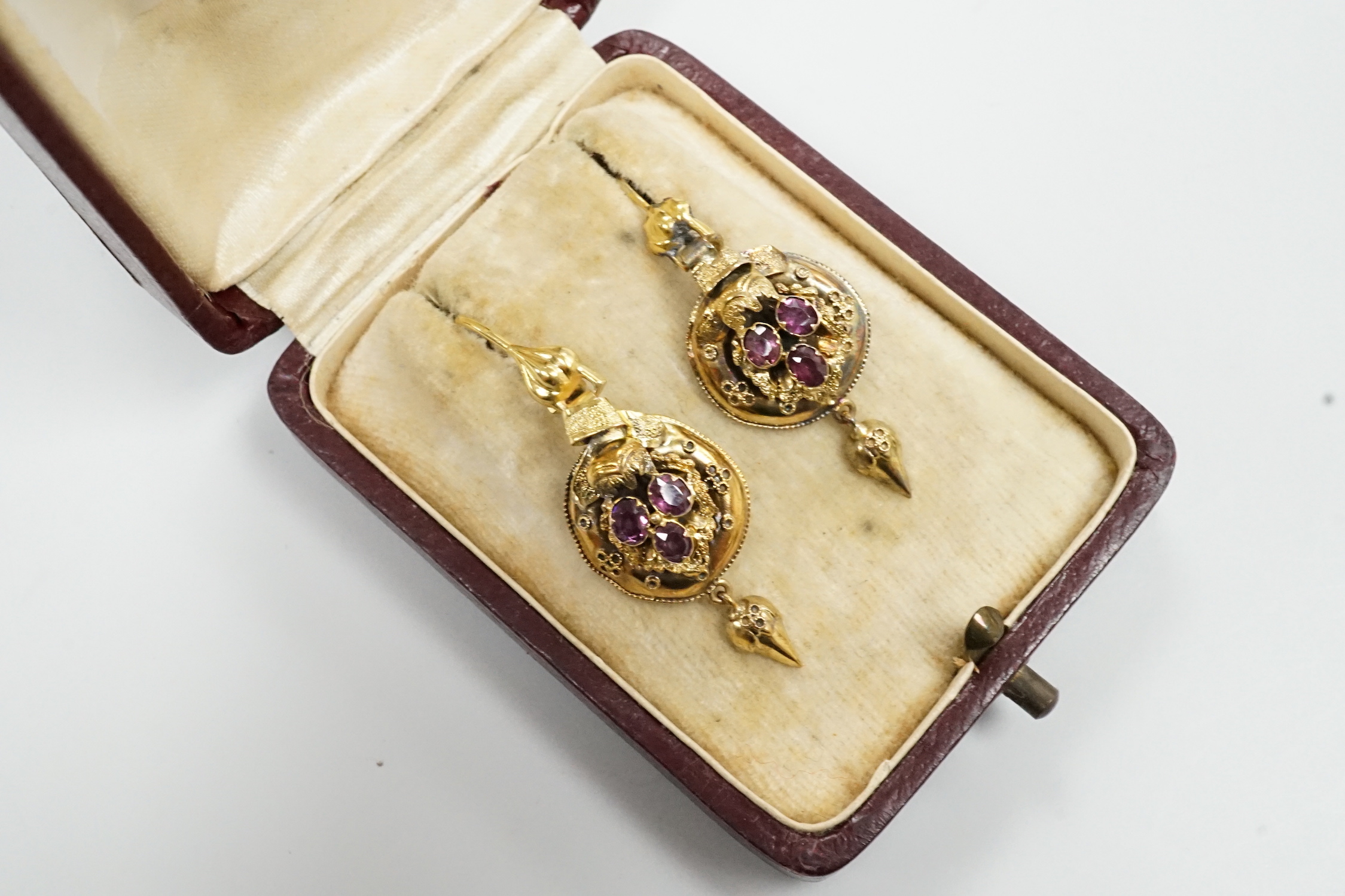 A pair of 19th century yellow metal and three stone garnet set drop earrings, overall 40mm, gross weight 3.4 grams.